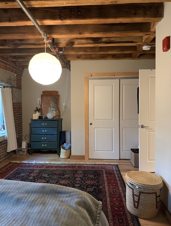 58 13th Street, Unit 112 Boston, MA 02129 - Photo 10 of 11 a bedroom with a bed and a mirror