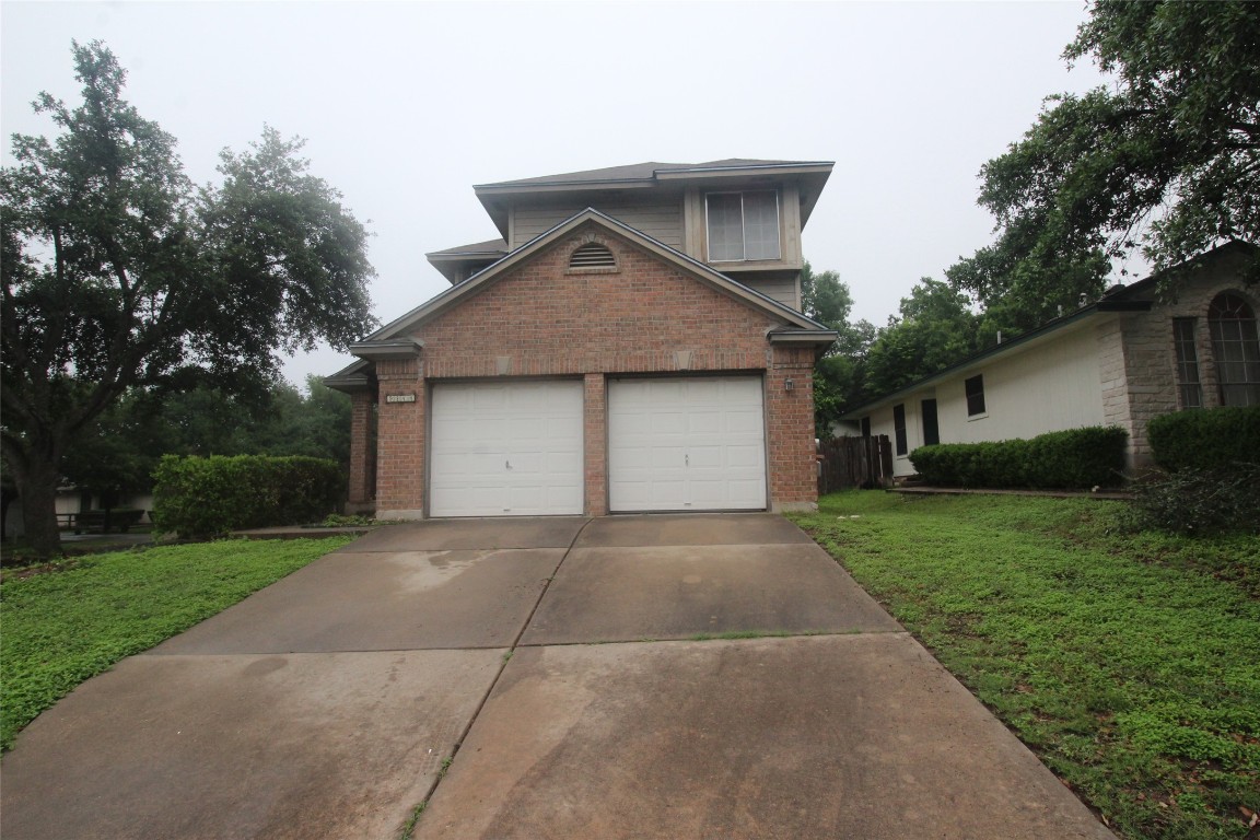 9244 Vigen Circle Austin, TX 78748 - Photo 1 of 1 a front view of a house with a yard and garage