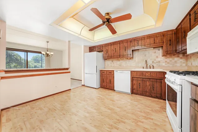 a kitchen with a stove a sink and a refrigerator