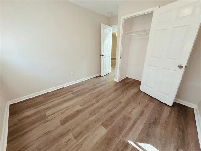 an empty room with wooden floor
