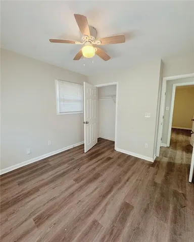 a view of an empty room and wooden floor