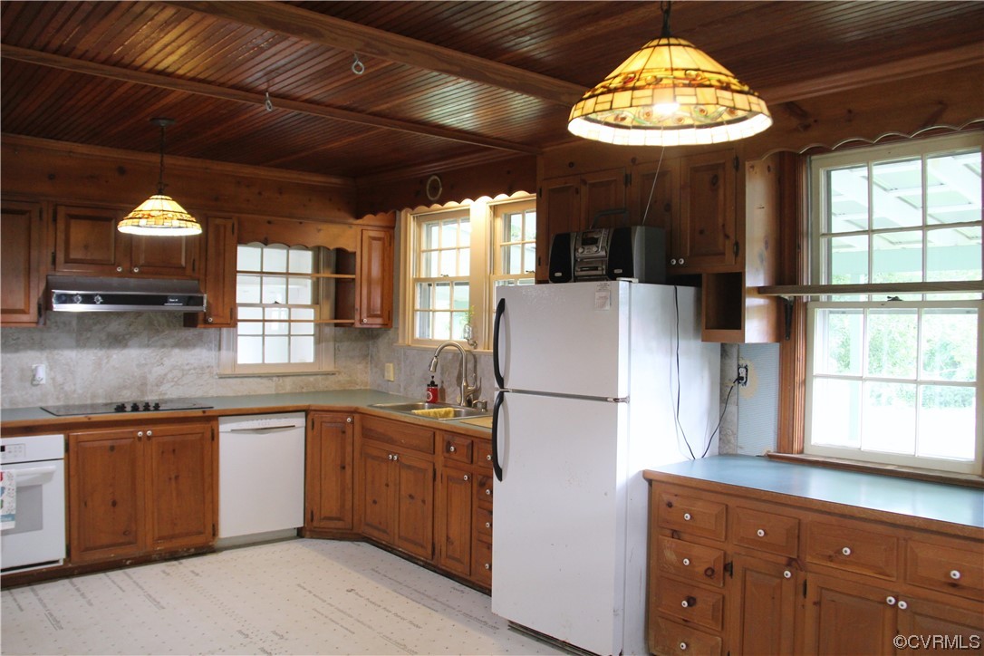 132 Carter Road Cumberland, VA 23040 - Photo 40 of 45 a kitchen with stainless steel appliances granite countertop a sink a refrigerator and wooden cabinets