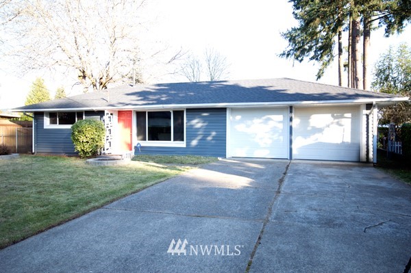 866 Queen Avenue Northeast Renton, WA 98056 - Photo 1 of 15 a front view of a house with a yard and garage