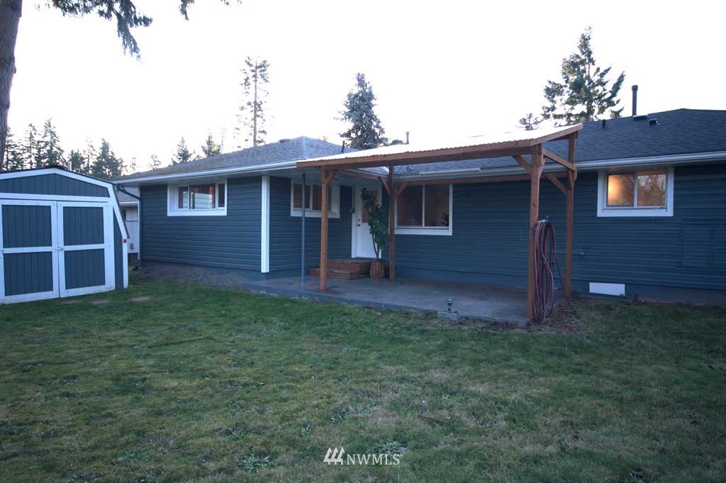 866 Queen Avenue Northeast Renton, WA 98056 - Photo 13 of 15 a view of a yard in front of a house with large windows