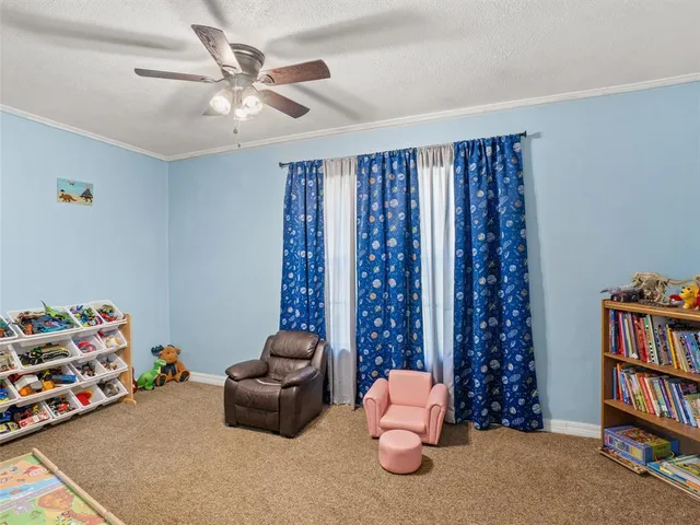 a living room with furniture toys and a book shelf