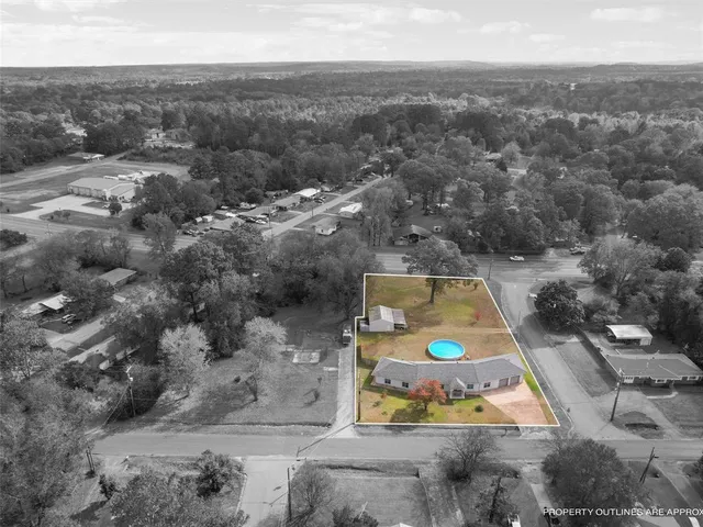 an aerial view of a house with a swimming pool