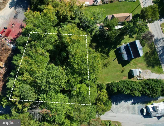 an aerial view of a house with yard
