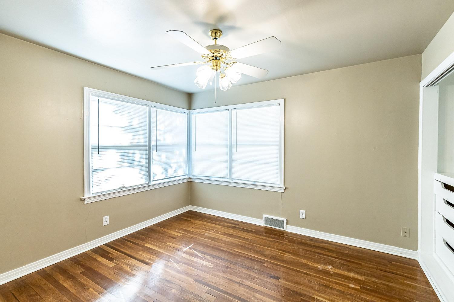 3708 27th Street Lubbock, TX 79410 - Photo 18 of 23 a view of an empty room with window and wooden floor