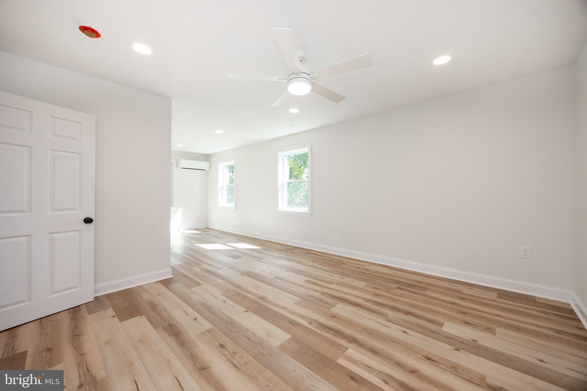 428 Adair Road Holmes, PA 19043 - Photo 22 of 59 a view of an empty room with window and wooden floor