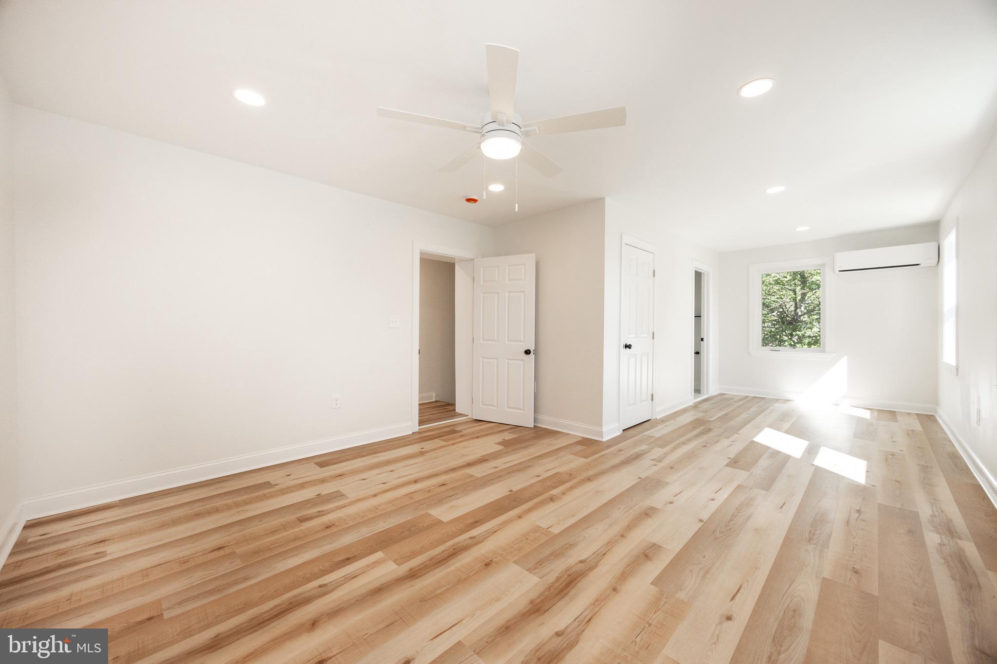 428 Adair Road Holmes, PA 19043 - Photo 23 of 59 a view of an empty room with wooden floor and a window