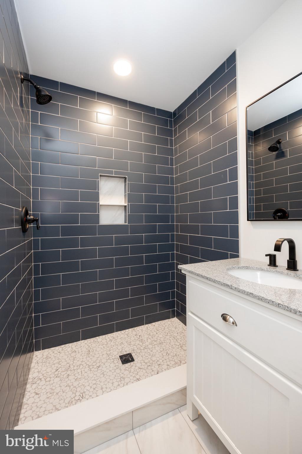 428 Adair Road Holmes, PA 19043 - Photo 27 of 59 a bathroom with a sink a toilet a mirror and shower