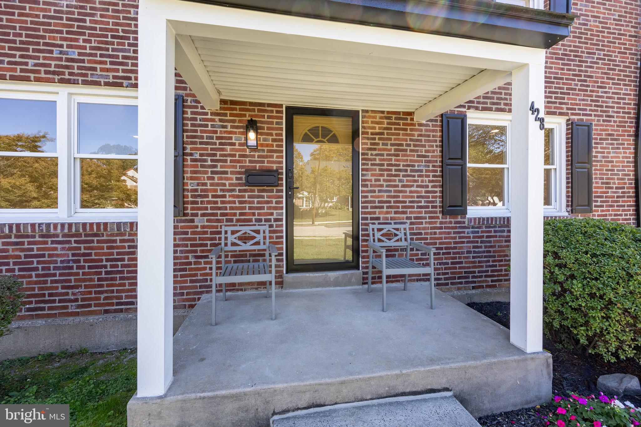 428 Adair Road Holmes, PA 19043 - Photo 3 of 59 a view of a brick house with a large windows