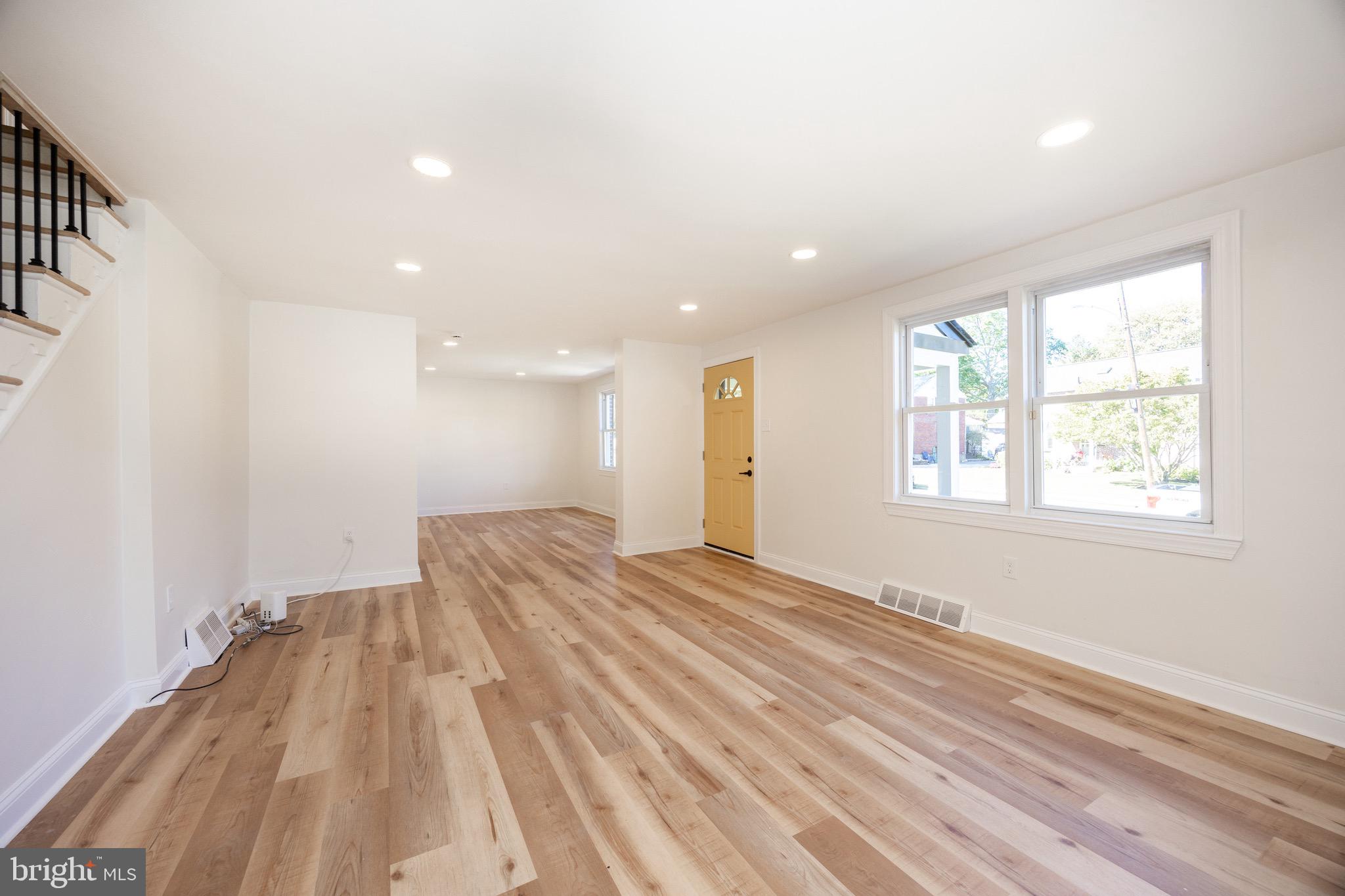 428 Adair Road Holmes, PA 19043 - Photo 10 of 59 a view of an empty room with wooden floor and a window