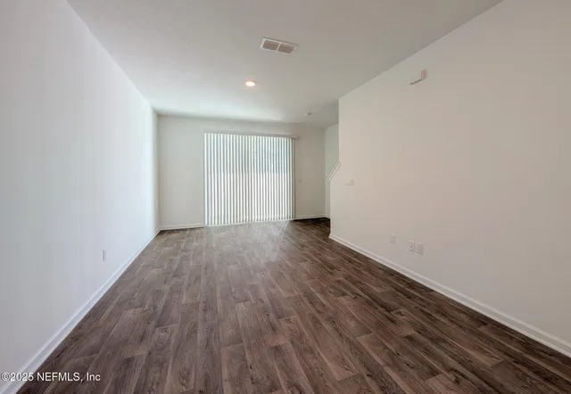a view of room with wooden floor