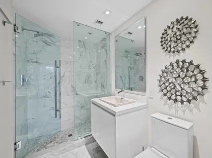 a bathroom with a sink mirror and shower