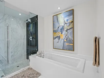 a bathroom with a bathtub and a shower