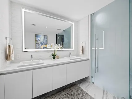 a bathroom with a double vanity sink and mirror