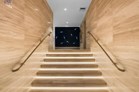 a living room with furniture and floor to ceiling window