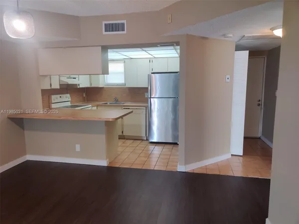 a kitchen with stainless steel appliances a refrigerator and a stove