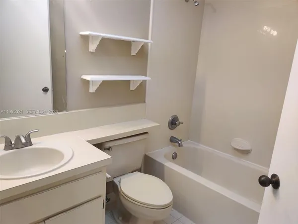 a bathroom with a sink a toilet and a bathtub