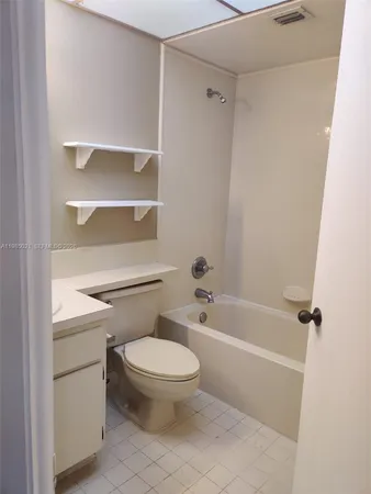 a bathroom with a toilet and a bath tub