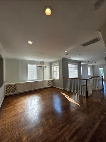 a living room with stainless steel appliances wooden floors and living room view