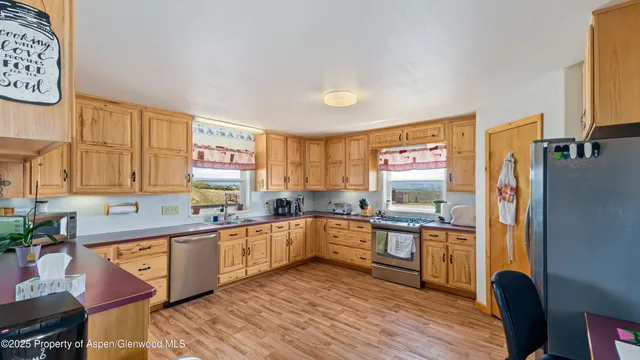 a kitchen with stainless steel appliances granite countertop a sink and cabinets