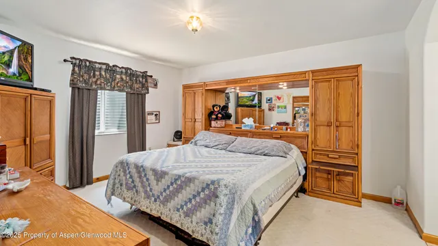 a bed sitting in a bedroom next to a window