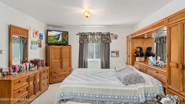 a bedroom with a large bed and a large window