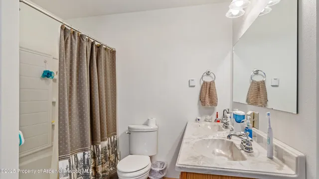 a white toilet sitting next to a bathroom sink