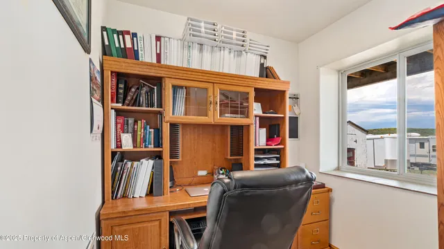 a living room with furniture and a book shelf