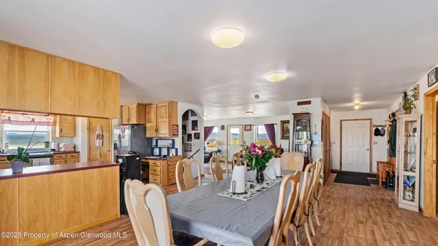 a view of a dining room with furniture a chandelier and wooden floor