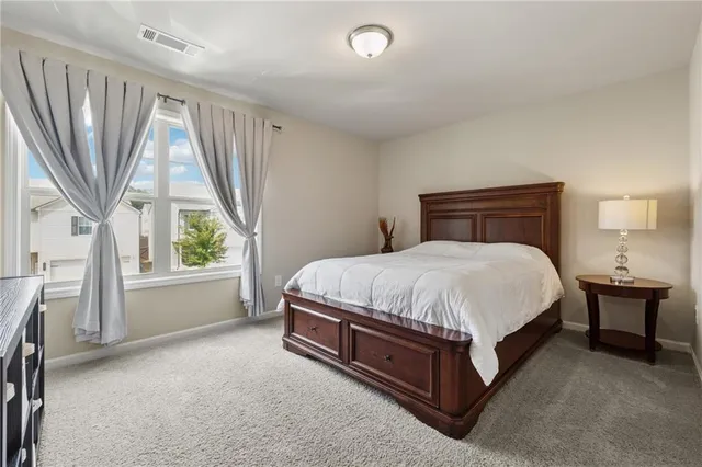 a bed sitting in a room next to a window