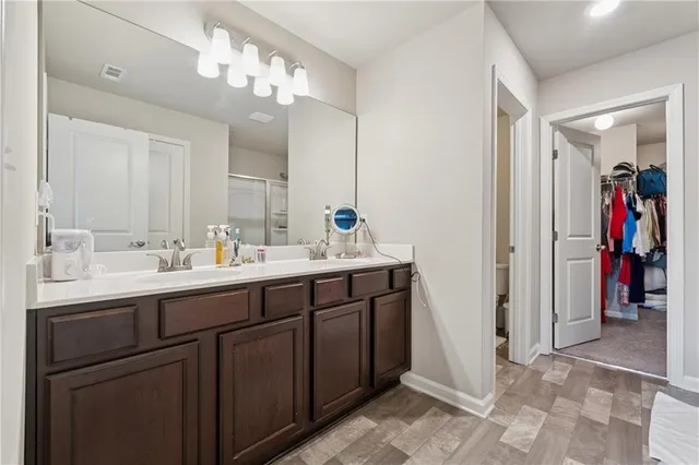 a bathroom with a double vanity sink and a mirror