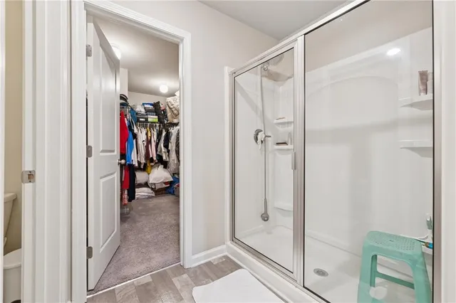 a view of a hallway with a glass shower door
