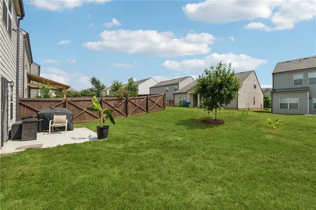 a view of a house with a backyard porch and sitting area