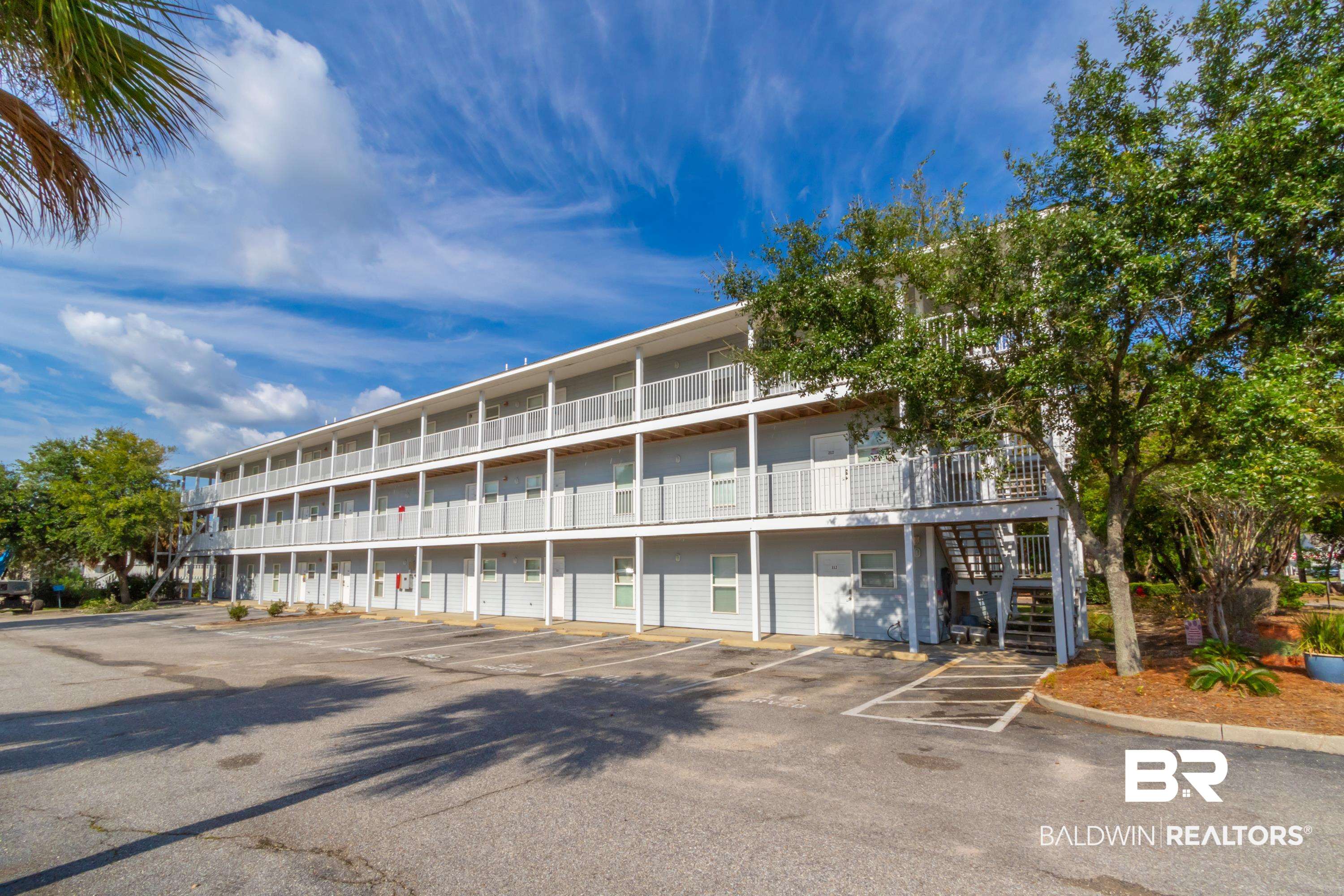 25957 Canal Road, Unit 208 Orange Beach, AL 36561 - Photo 22 of 28 Multi-level property exterior featuring light gray siding and white railings