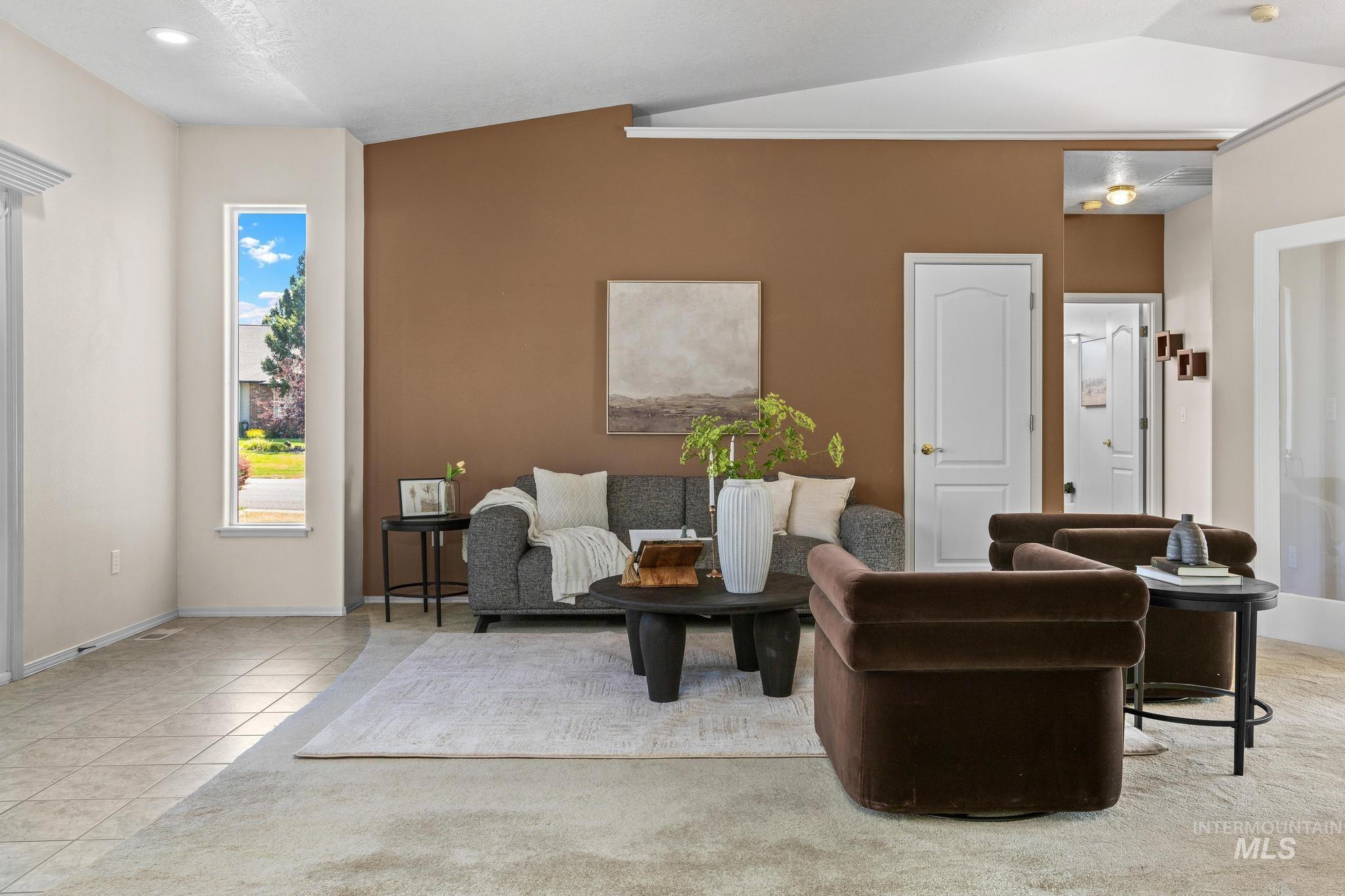 15181 Drury Way Caldwell, ID 83607 - Photo 9 of 49 Living area featuring a warm accent wall, recessed lighting, and a vaulted ceiling