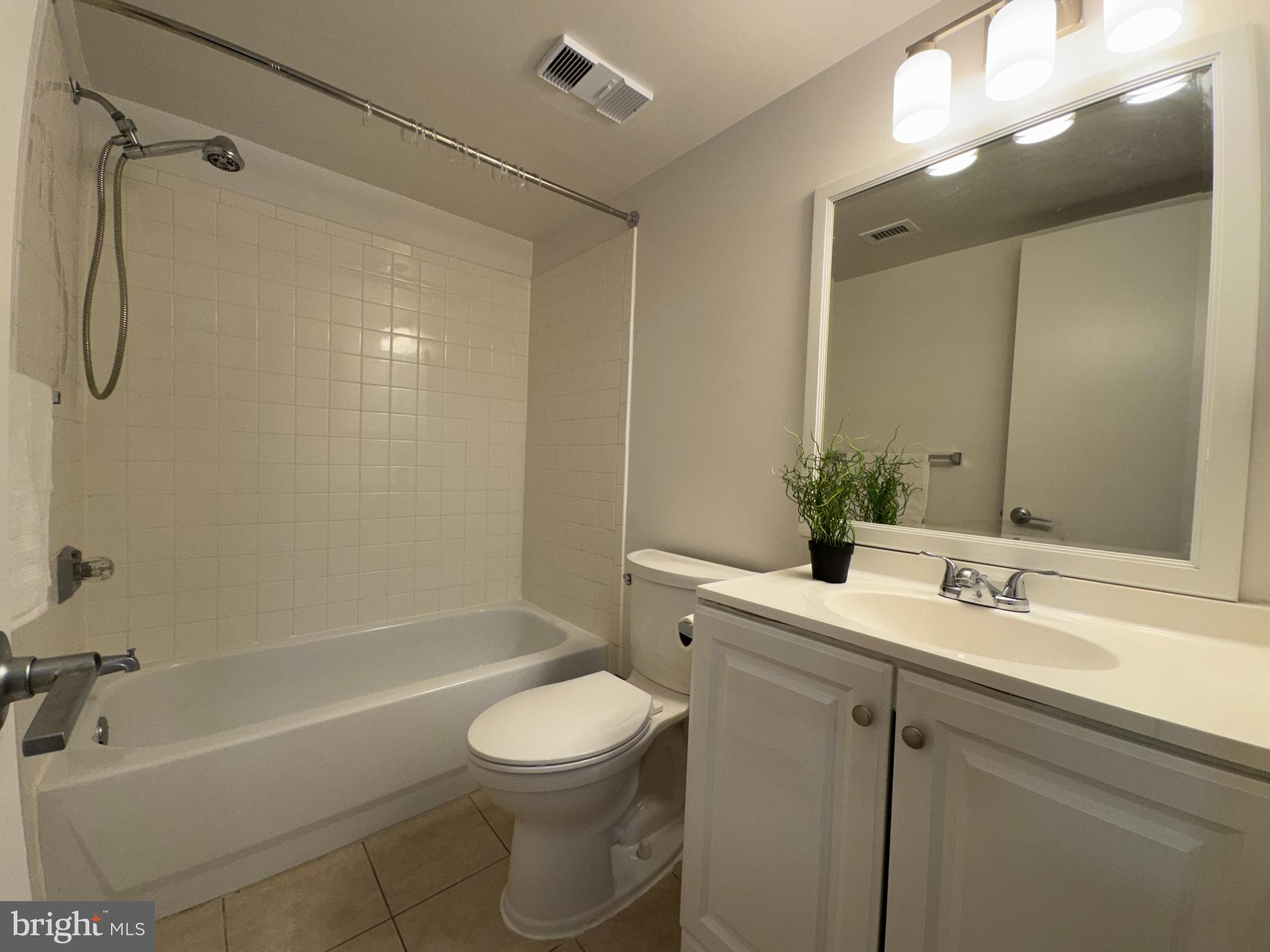 5916 Cove Landing Road, Unit 204 Burke, VA 22015 - Photo 14 of 20 a bathroom with a sink a toilet and shower