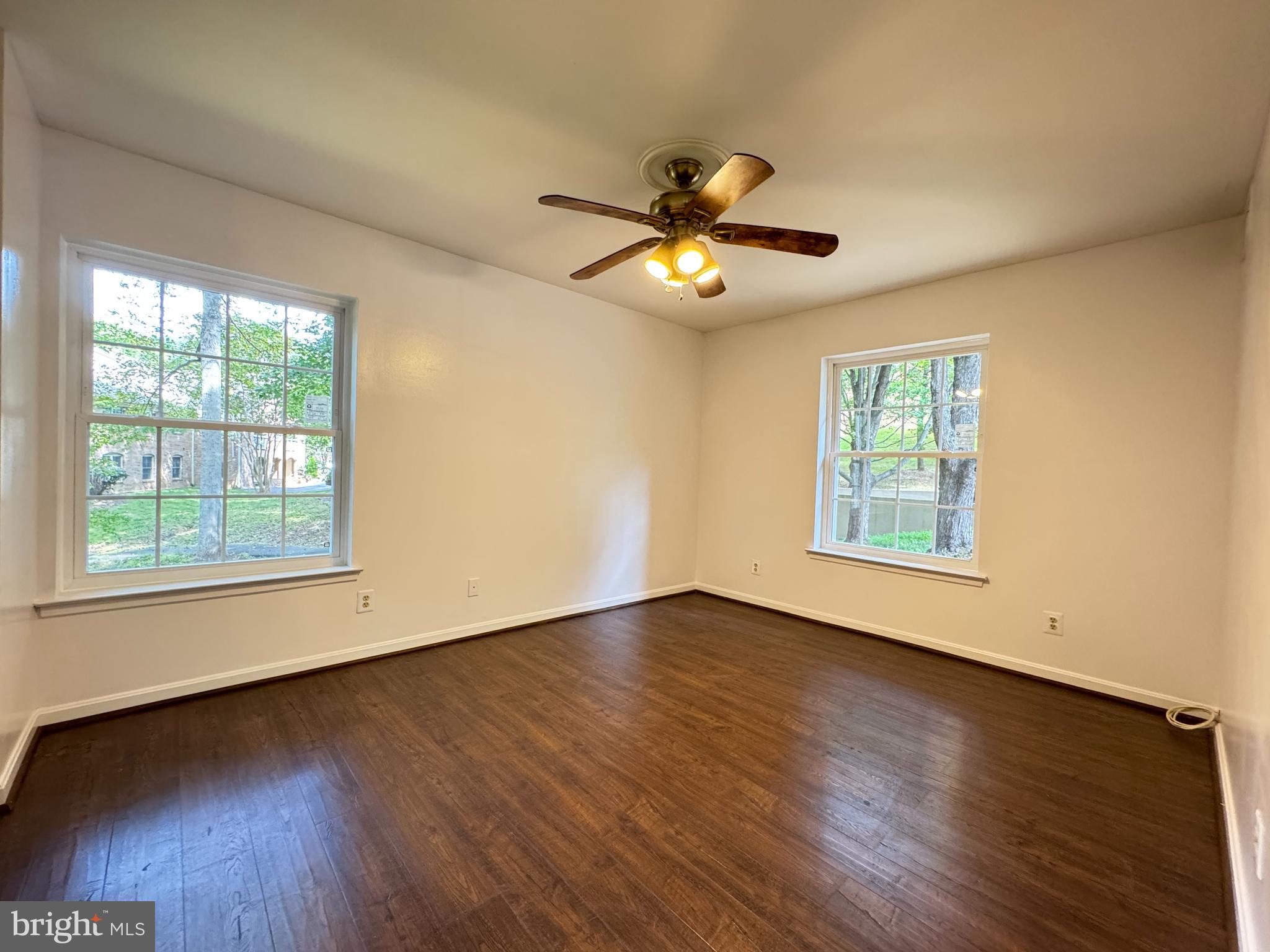 5916 Cove Landing Road, Unit 204 Burke, VA 22015 - Photo 15 of 20 a view of an empty room with wooden floor and a window