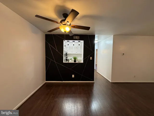 a view of a living room with wooden floor