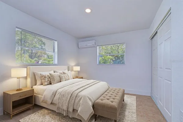 a bedroom with a bed and a window