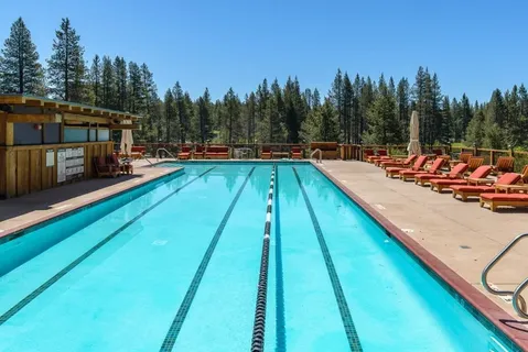 a view of a building with a swimming pool and sitting area