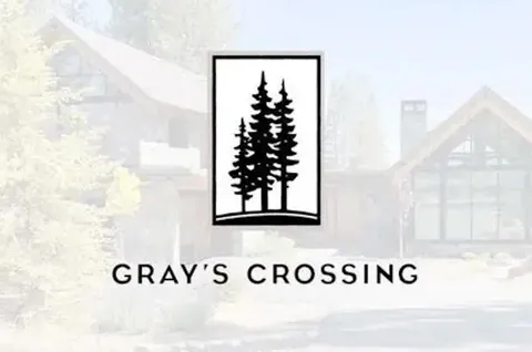 a man sitting in a park with large trees