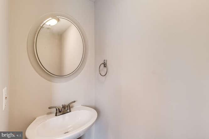 768 Carroll Street Baltimore, MD 21230 - Photo 11 of 26 a bathroom with a sink and a mirror