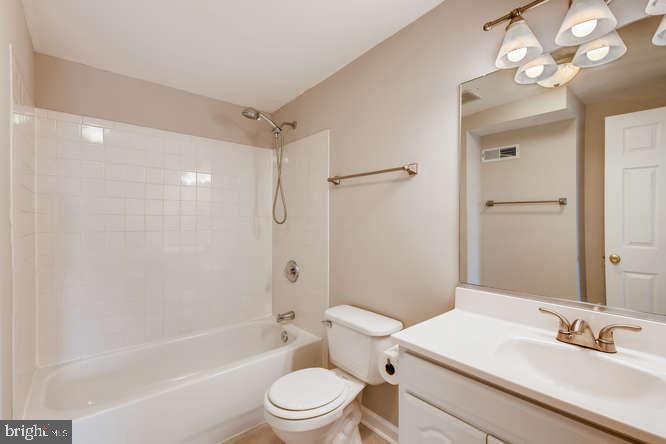 768 Carroll Street Baltimore, MD 21230 - Photo 22 of 26 a bathroom with a sink a toilet a mirror and shower