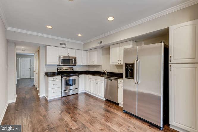 768 Carroll Street Baltimore, MD 21230 - Photo 8 of 26 a kitchen with stainless steel appliances a refrigerator sink and microwave
