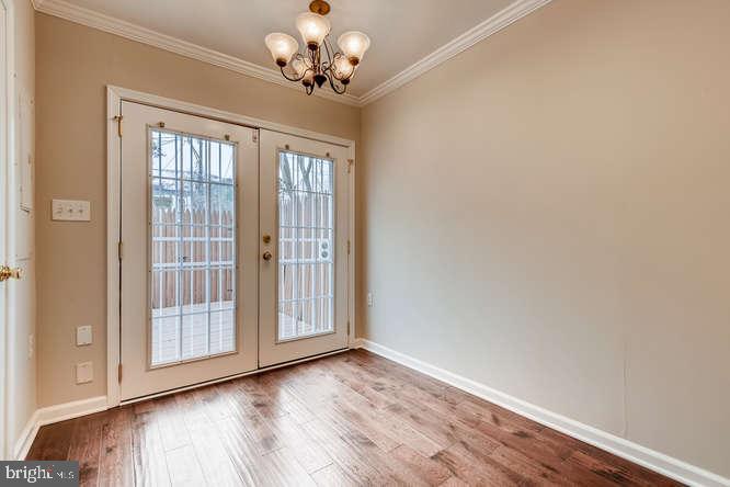 768 Carroll Street Baltimore, MD 21230 - Photo 10 of 26 a view of an empty room with a window and wooden floor