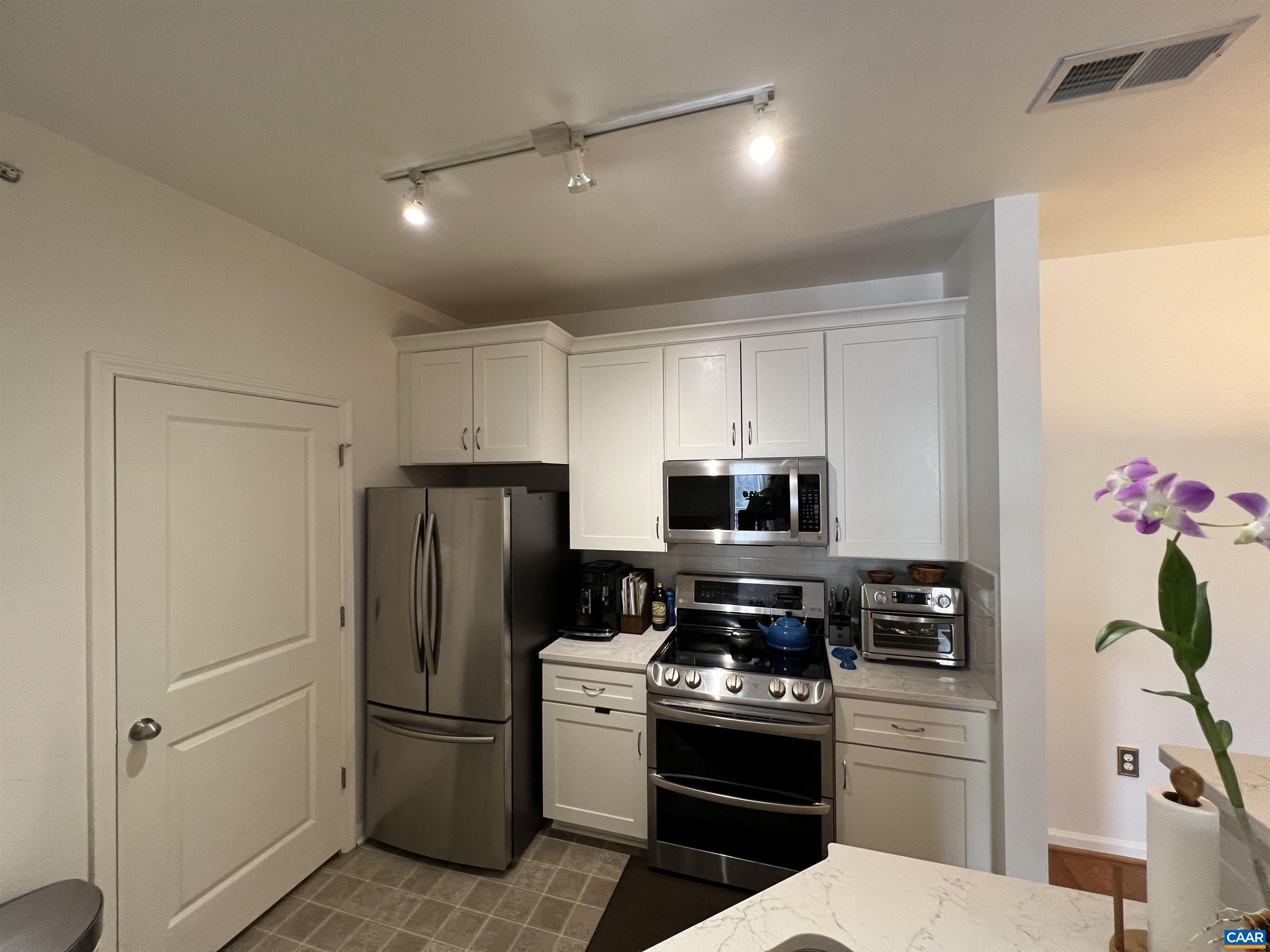 740 Walker Square, Unit 3A Charlottesville, VA 22903 - Photo 11 of 29 a kitchen with stainless steel appliances a refrigerator stove and microwave