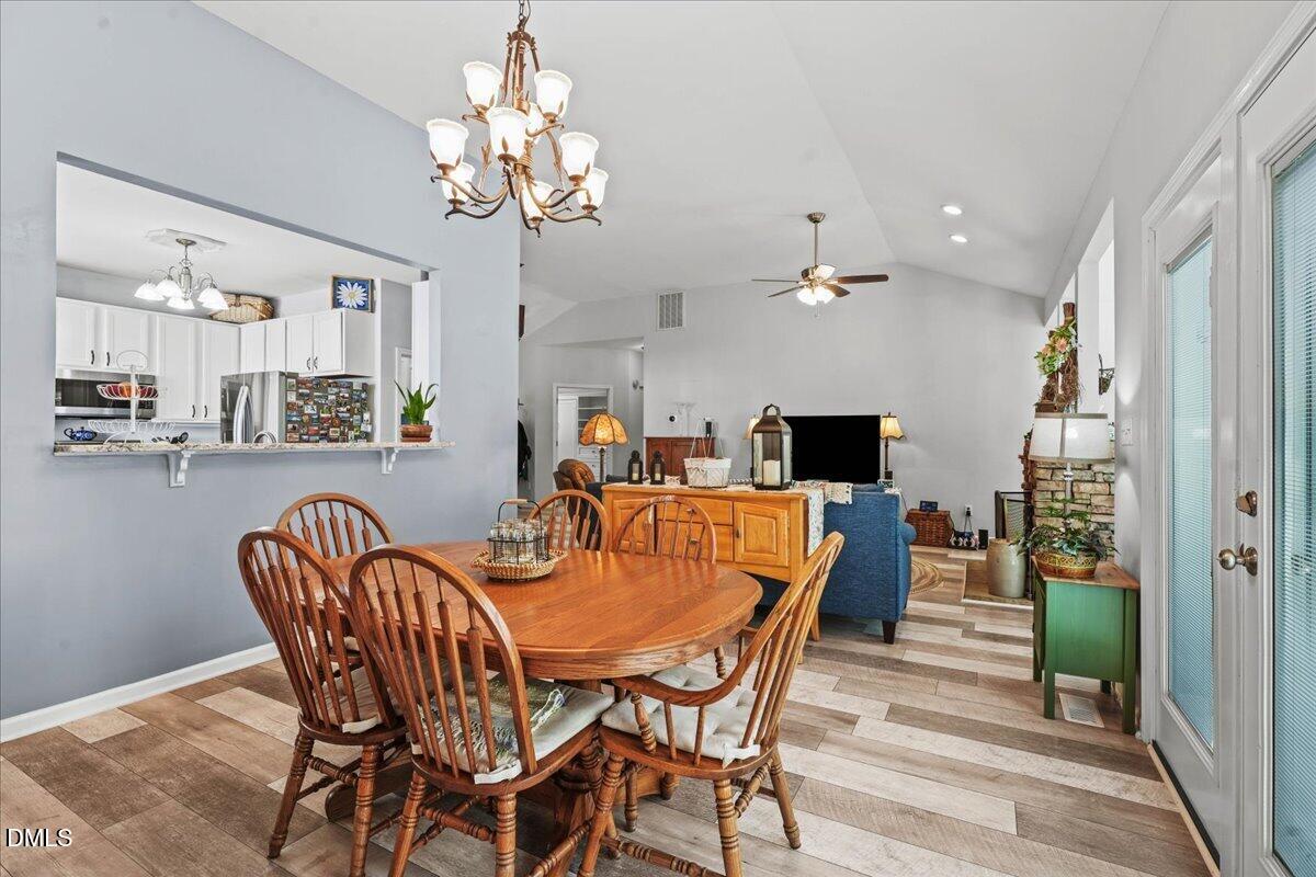 3331 Swinford Court Raleigh, NC 27604 - Photo 13 of 27 a view of a dining room with furniture and chandelier